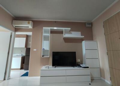 Modern living room with a TV and shelving unit