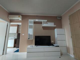 Modern living room with a TV and shelving unit