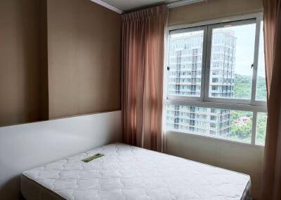 Bedroom with a large window and minimal furnishings