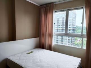 Bedroom with a large window and minimal furnishings