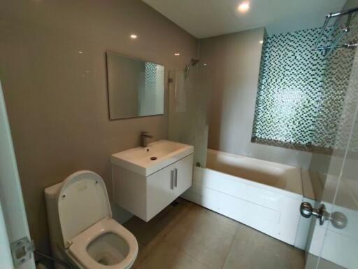 Modern bathroom with white fixtures and glass shower