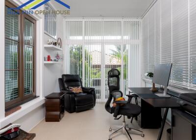 Home office with large windows and modern furniture