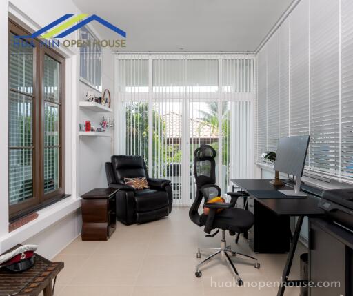 Home office with large windows and modern furniture