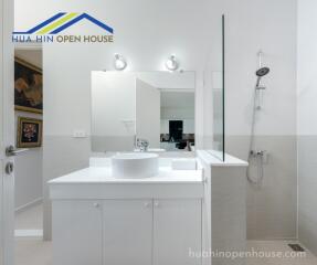 Modern bathroom with white vanity and walk-in shower