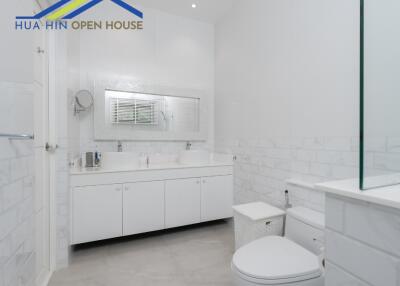 Modern white bathroom with large mirror and double sink