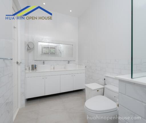 Modern white bathroom with large mirror and double sink