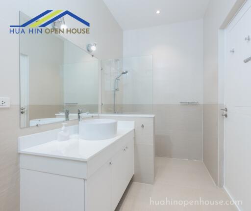 Modern bathroom with vanity, sink, and shower