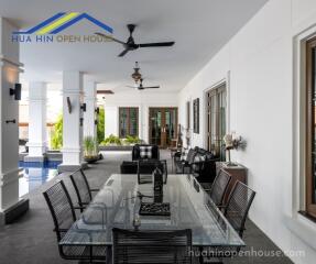 Outdoor dining area with glass table and chairs