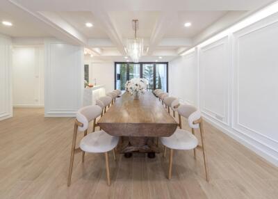 Spacious dining area with a large wooden table and elegant chairs