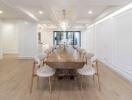 Spacious dining area with a large wooden table and elegant chairs