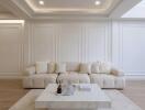 Elegant living room with beige couch, marble coffee table, and stylish wall paneling