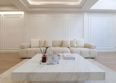 Modern living room with a white couch and a marble coffee table