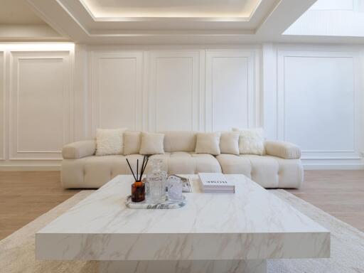 Modern living room with a white couch and a marble coffee table