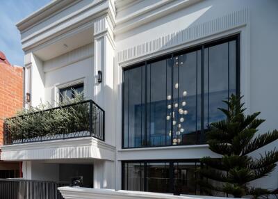 Elegant facade of a modern building with large windows and balcony