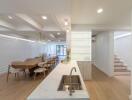 Modern kitchen and dining area with a marble countertop and wooden dining table