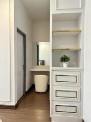 Bedroom with vanity area and storage