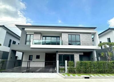 modern double-story house with large front yard