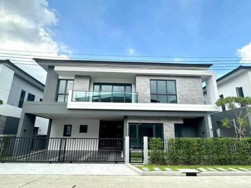 modern double-story house with large front yard