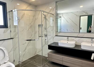 Modern bathroom with glass shower and double sink