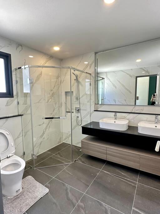 Modern bathroom with glass shower and double sink