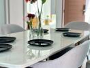 Modern dining table set with chairs and decorative elements