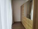 Closet area with wooden floor and large mirrored wardrobes in a bedroom