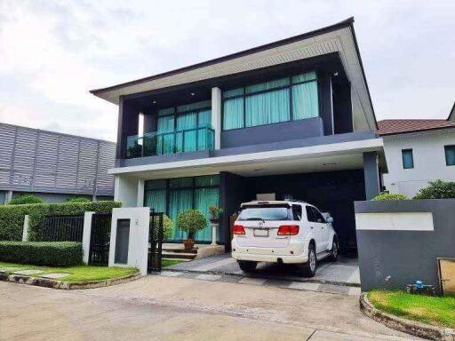 Modern two-story house with driveway and car