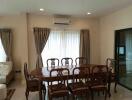 Elegant dining area with a large wooden table and chairs, adjacent to living space