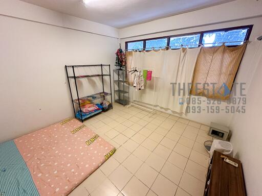 Simple bedroom with tiled floor and minimal furnishings