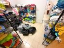 Clothing storage room with shelves full of neatly folded clothes and plastic bags on the tiled floor