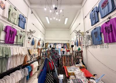 Clothing shop interior with various garments and accessories on display