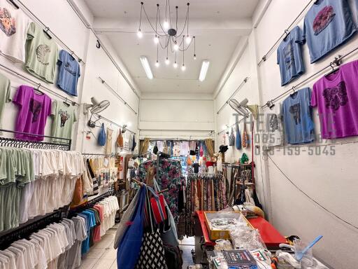 Clothing shop interior with various garments and accessories on display