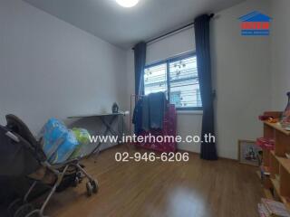 Bedroom with wooden floor, stroller, table, curtains, and shelving