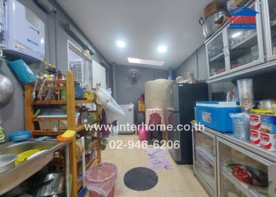 Cluttered kitchen space with various kitchen items and appliances