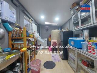 Cluttered kitchen space with various kitchen items and appliances