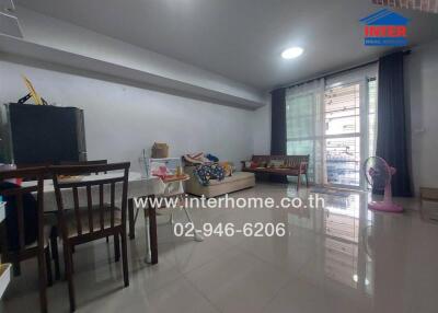 Living room with dining area and large window