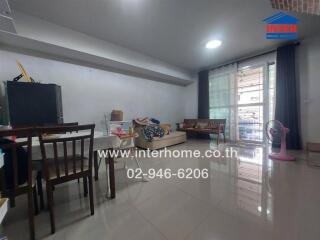 Living room with dining area and large window