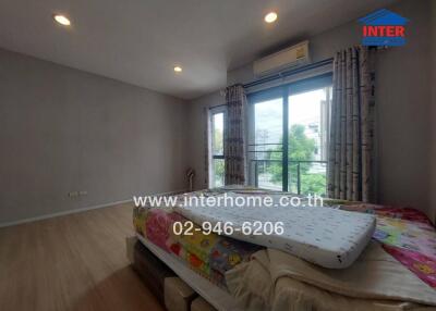 Spacious bedroom with large window and balcony access