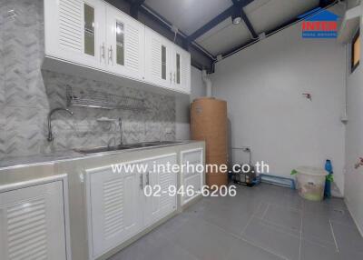 Modern kitchen with white cabinetry and tiled backsplash