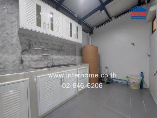 Modern kitchen with white cabinetry and tiled backsplash