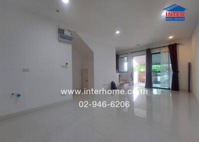 Bright and spacious living room with large windows and balcony access