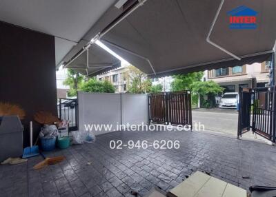 Photo of a garage space with a partial view of the street and surrounding houses