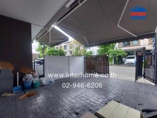 Photo of a garage space with a partial view of the street and surrounding houses