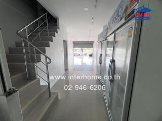 Building corridor with staircase and refrigerator