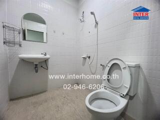 Bathroom with sink, toilet, mirror, and shower