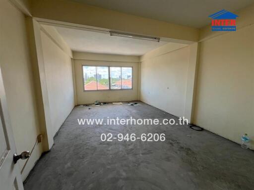 Unfurnished room with large window and concrete floor