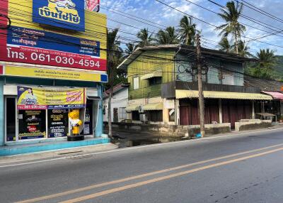 Street view of a commercial area with shops and buildings