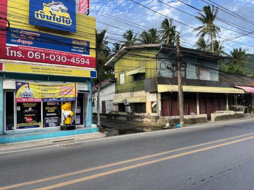 Street view of a commercial area with shops and buildings