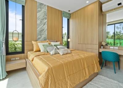 Modern bedroom with large bed, wooden wall paneling, ample natural light, and a small desk setup