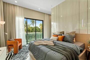 Modern bedroom with large bed, floor-to-ceiling windows, and balcony view.